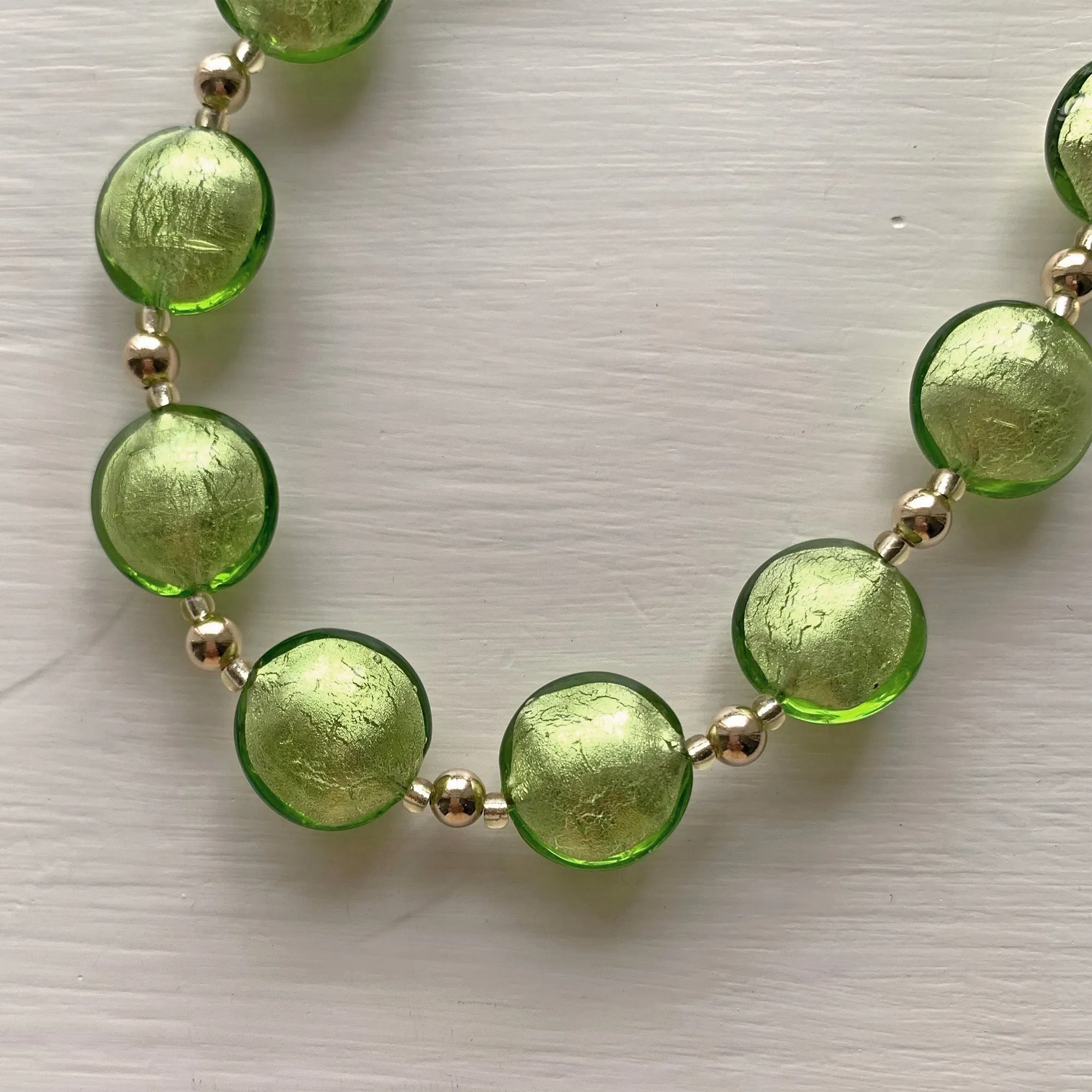 Necklace with light green (lime, peridot) Murano glass medium lentil beads on gold